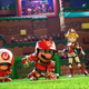 Mario stands next to Toad, Peach, and Luigi on the pitch in Mario Strikers: Battle League.